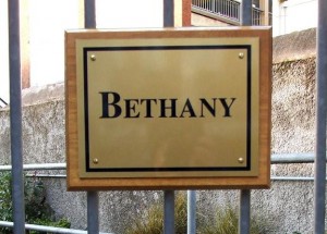 Immitation brass plaque on timber backing