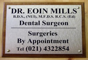 Dental surgery plaque: brushed stainless steel effect on timber backing