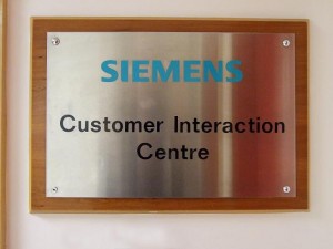 Stainless steel plaque with stick-on lettering and timber backing